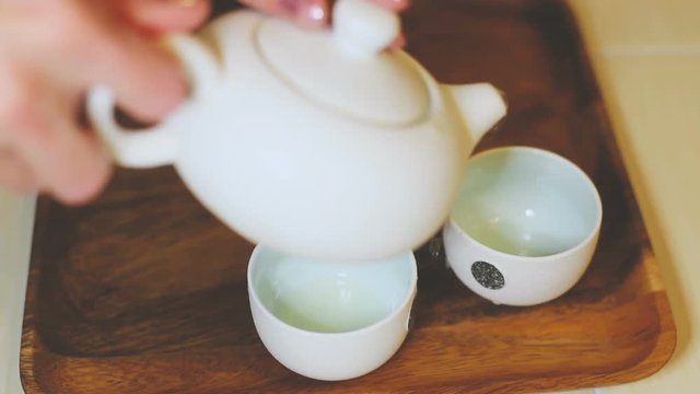 Traditional Chinese tea ceremony, green tea in a small teapot and white cups