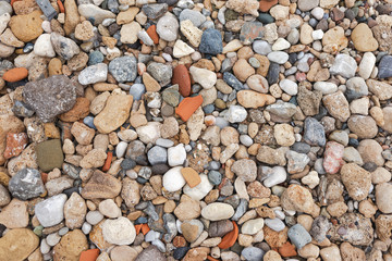 Grunge stony colourful pebble background. Horizontal color photography.