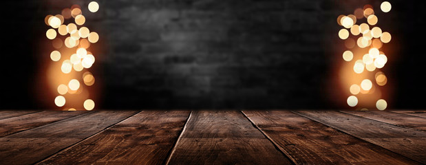 Empty dark room scene. Old brick wall and wooden floor. Blur bokeh lights. Abstract bokeh light....