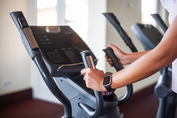Young fitness woman working out in the gym. Woman working out on exercise bike