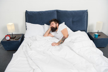 Obraz na płótnie Canvas Sleep disorders concept. Man bearded hipster having problems with sleep. Guy lying in bed try to relax and fall asleep. Relaxation techniques. Violations of sleep and wakefulness. Insomnia