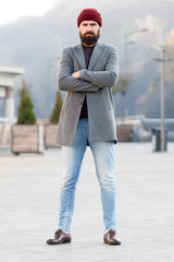 Fototapeta premium Stylish casual outfit spring season. Menswear and male fashion concept. Man bearded hipster stylish fashionable coat and hat. Comfortable outfit. Refreshing walk. Hipster outfit and hat accessory