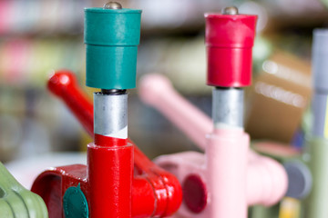 Detail of manual hand press buton machines with blurred background. Saara, Rio de Janeiro, Brazil. 2019