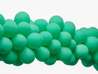 Green color decorated balloons in a row over white background , with clipping path