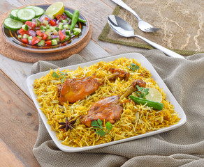 Chicken Biryani, a yummy & fluffy rice dish with spicy savory chicken pieces with salad.