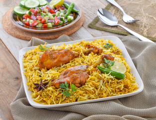 Chicken Biryani, a yummy & fluffy rice dish with spicy savory chicken pieces with salad.
