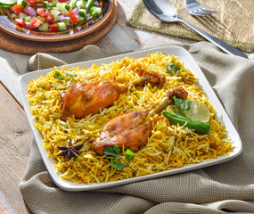 Chicken Biryani, a yummy & fluffy rice dish with spicy savory chicken pieces with salad.