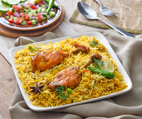 Chicken Biryani, a yummy & fluffy rice dish with spicy savory chicken pieces with salad.
