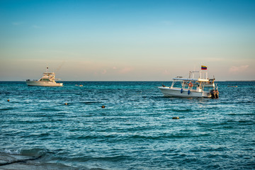 Boats anchored during a dramatic and beautiful sunset. Los Roques National Park 