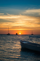 Boats anchored during a dramatic and beautiful sunset. Los Roques National Park 