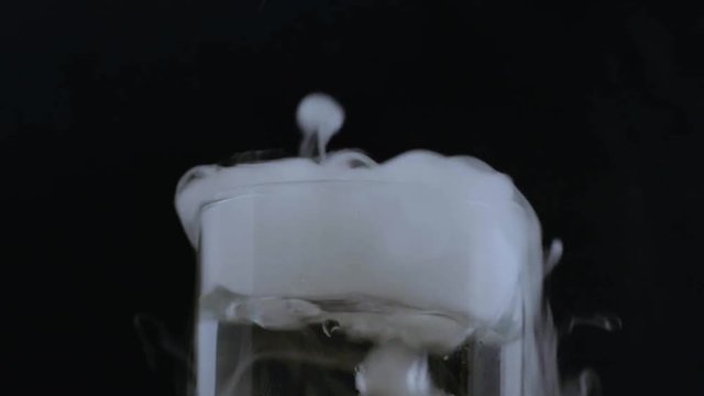 Close up shot of smoking bubbling beaker
