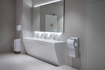 Hygiene, modern lifestyle and sanitary fixtures concept. Indoor shot of airport restroom with clean...