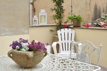Terrazza fiorita con sedie e tavolo