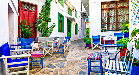 Traditional narrow streets with cute cafe bars in Greece. Skopelos island, Sporades