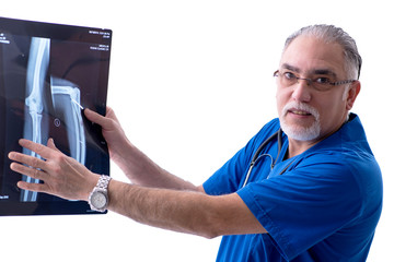 White bearded old doctor radiologist working in clinic 
