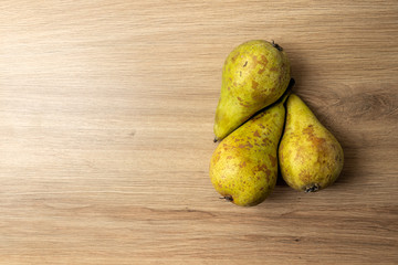 Three pears on a wooden table