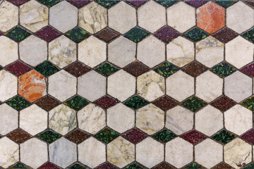 Ornate mosaic of colorful tiles on the floor of a church in Rome, Italy