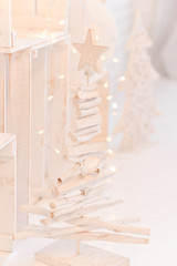 Fototapeta na wymiar wooden Christmas tree details for new year christmas decor in monochrome white light palette for background