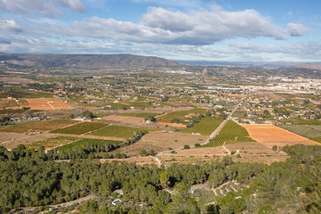 A view of rural farmland area from mountains in Spain. Small town in the background.