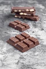 pieces of chocolate on gray marbled textured background