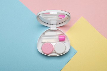 Accessories for contact lenses on a multicolored background. The view from the top.
