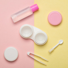 Accessories for contact lenses on a multicolored background. The view from the top.