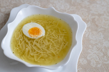 Appetizing noodles in a chicken broth with boiled egg