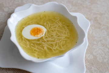 Appetizing noodles in a chicken broth with boiled egg