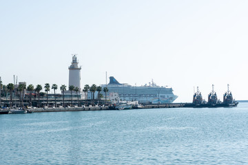 Fototapeta na wymiar Port of Malaga with the lighthouse and passenger cruise in the background
