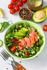 Diet menu concept. Summer Healthy salad with quinoa, Tomatoes, Salmon, Avocado and arugula.