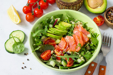 Diet menu concept. Summer Healthy salad with quinoa, Tomatoes, Salmon, Avocado and arugula.