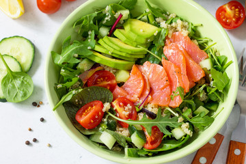 Diet menu concept. Summer Healthy salad with quinoa, Tomatoes, Salmon, Avocado and arugula.