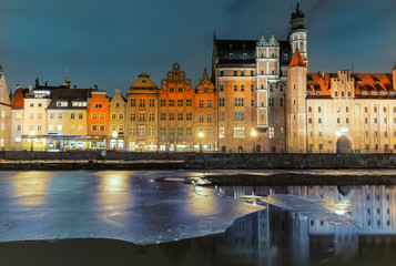 Fototapeta na wymiar Mariacka Gate and other sights of Gdansk on the bank of the Motlawa, evening view