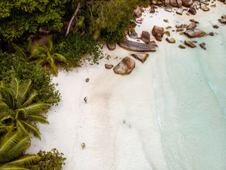 Aerial drone view of couple on the tropical beach of the Seychelles island