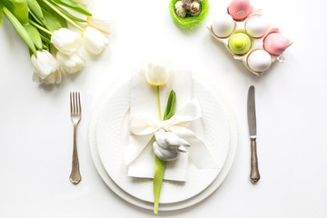 Easter dinner. Table setting with white tulip on table. Top view.