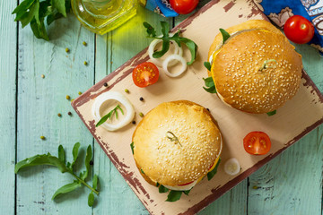 Arabic cuisine, Ramadan food. Delicious fresh Big sandwich - hamburger burger with vegetarian mung cutlets burger on a wooden kitchen table. Copy space.