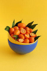 Kumquat fruits on a yellow background