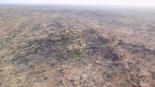 Aerial moves towards petroglyphs and cave art at Hargeisa, Somalia to reveal landscape.