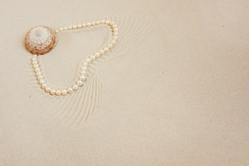 Fototapeta na wymiar Pearl necklace on white fine sand with sea shell. Luxury resort, ocean or sea wedding concept