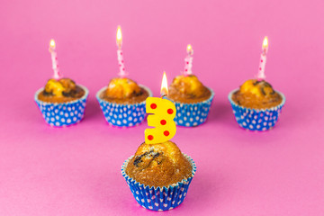 Happy birthday baked cakes with candels and flames on pink background. Party, dessert concept