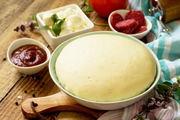 Pizza cooking. Food ingredients and spices for cooking Traditional delicious italian pizza.