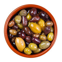 green and purple, mixed olives in clay bowl - isolated on white background