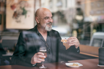 Mature man in a cafe enjoying a relaxing moment