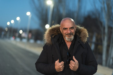 Elegant images of a mature man of 60 years during the night in the outskirts of the city