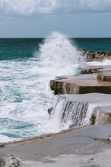 view of the sea and rocky coast strewn with stones. Windy weather and waves break on the shore
