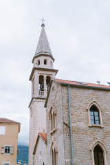 Fototapeta na wymiar old european church with narrow tower and bell