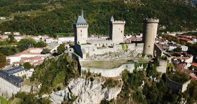 Aerial view of impressive medieval castle on rocky outcrop in French commune of Foix