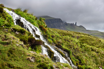 Fototapeta na wymiar Brides Veil WaterFalls creek to Loch Leathan at The Storr with Old Man of Storr peak in clouds on Isle of Skye Inner Hebrides Scotland UK