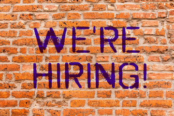 Conceptual hand writing showing We Re Hiring. Business photo showcasing Workforce Wanted New Employees Recruitment Brick Wall art like Graffiti motivational written on wall