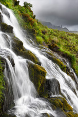 Flowing Bride's Veil WaterFalls to Loch Leathan at The Storr with Old Man of Storr peak in clouds on Isle of Skye Inner Hebrides Scotland UK